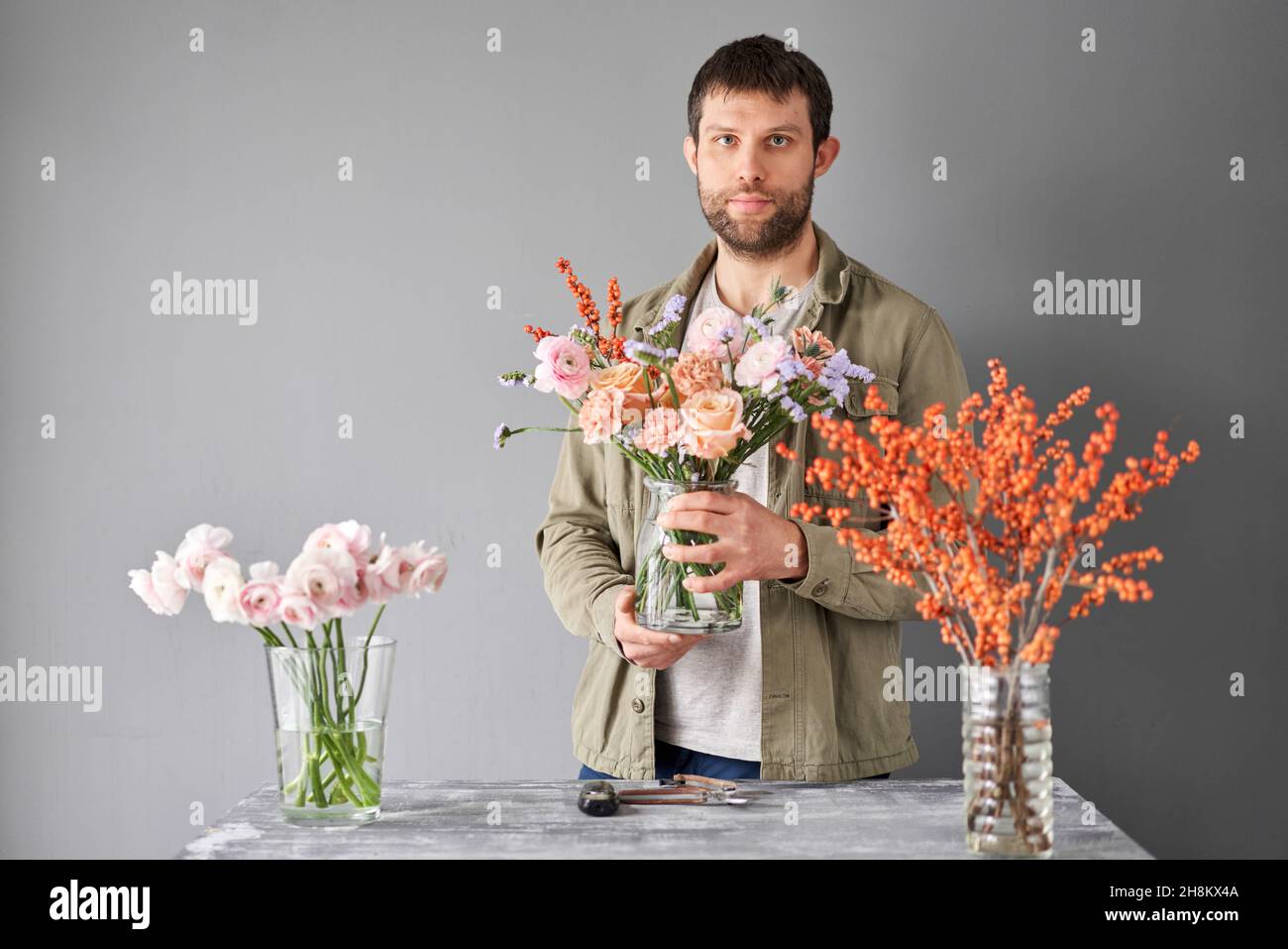 Portrait of a Male florist. Flowers bunch, set for home. Fresh cut flowers for decoration home. European floral shop. Delivery fresh cut flower Stock Photo