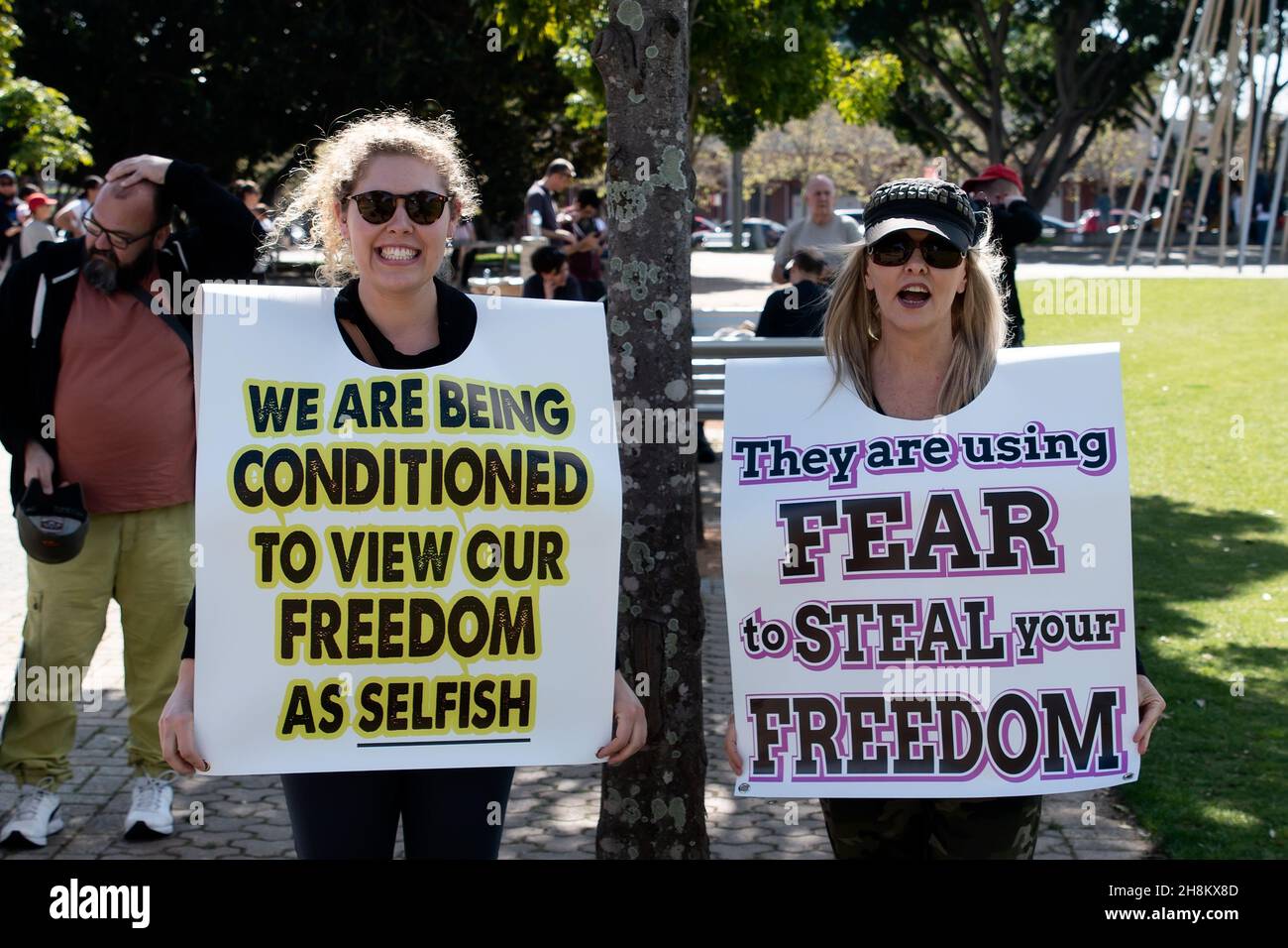 Two women pose holding up signs during the Freedom Day Rally on ...