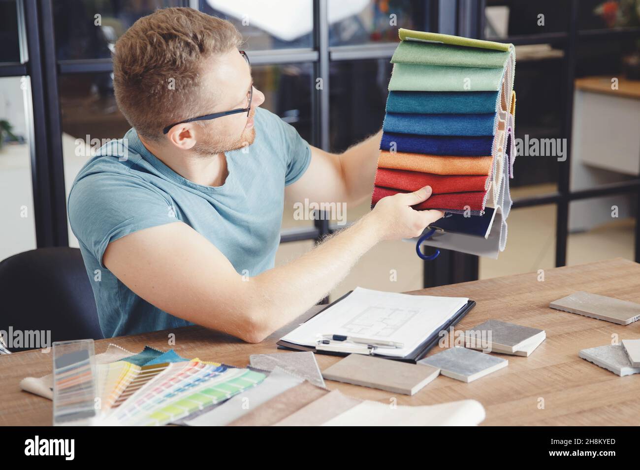 Author supervision of design project, male designer selects color of ...