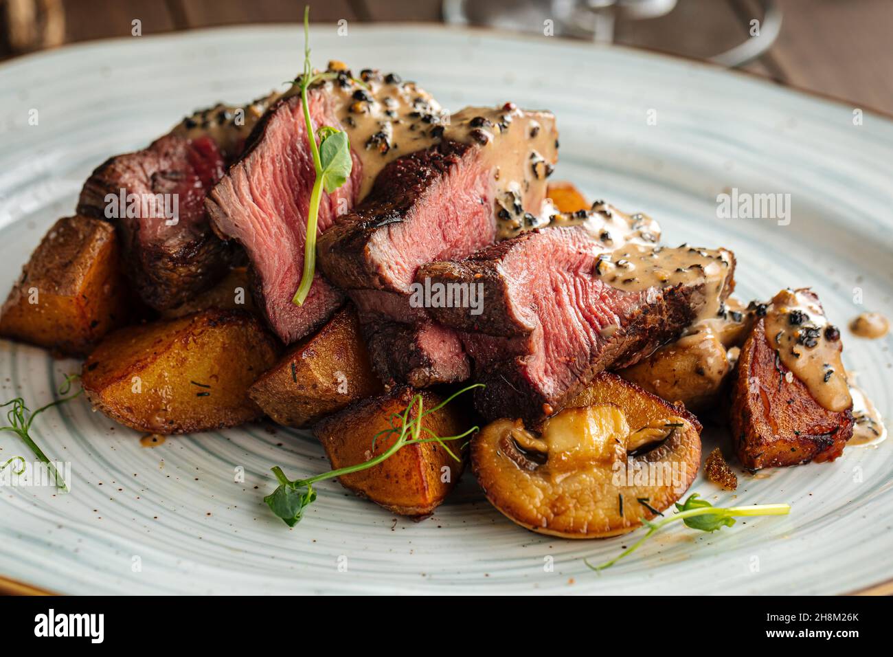 Beef medallions dish with potatoes and mushrooms Stock Photo