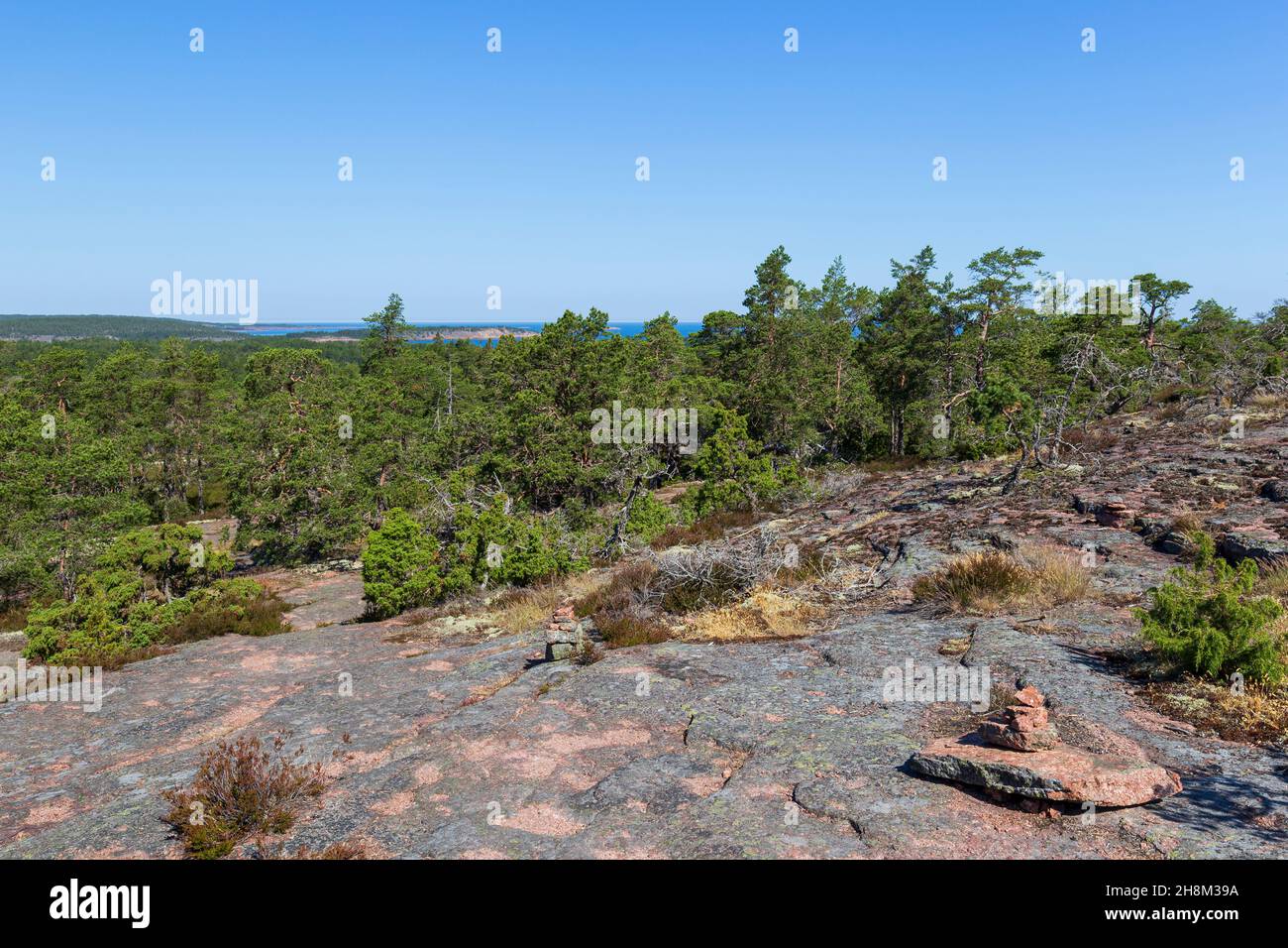Rocky, rugged and forested landscape along the Grottstigen cave nature trail at Geta in Åland Islands, Finland, on a sunny day in the summer. Stock Photo