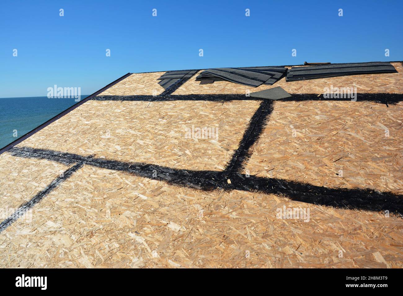Roofing construction and waterproofing. A closeup of OSB roof deck