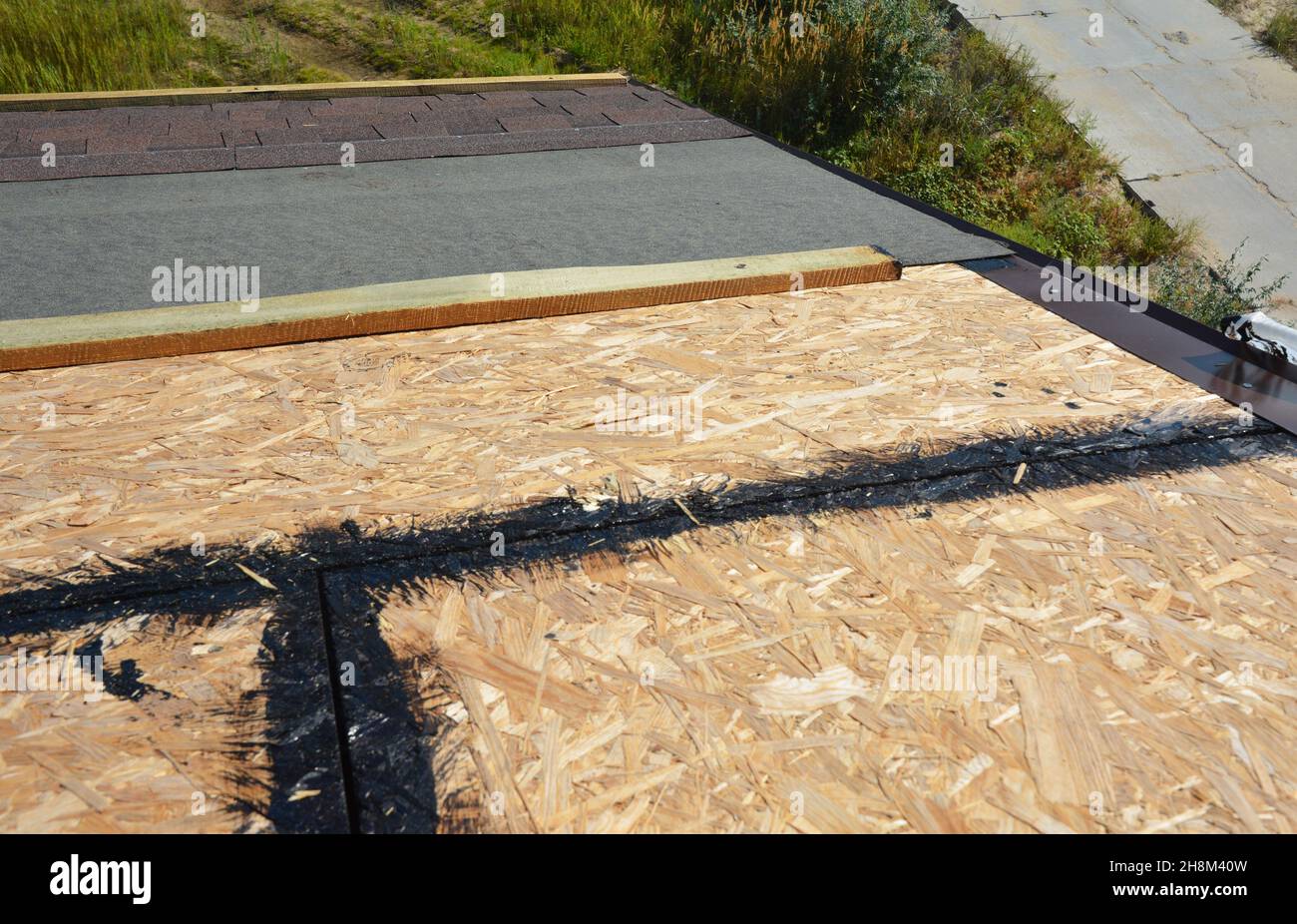 Installing asphalt shingles on the roof. A closeup of asphalt shingles