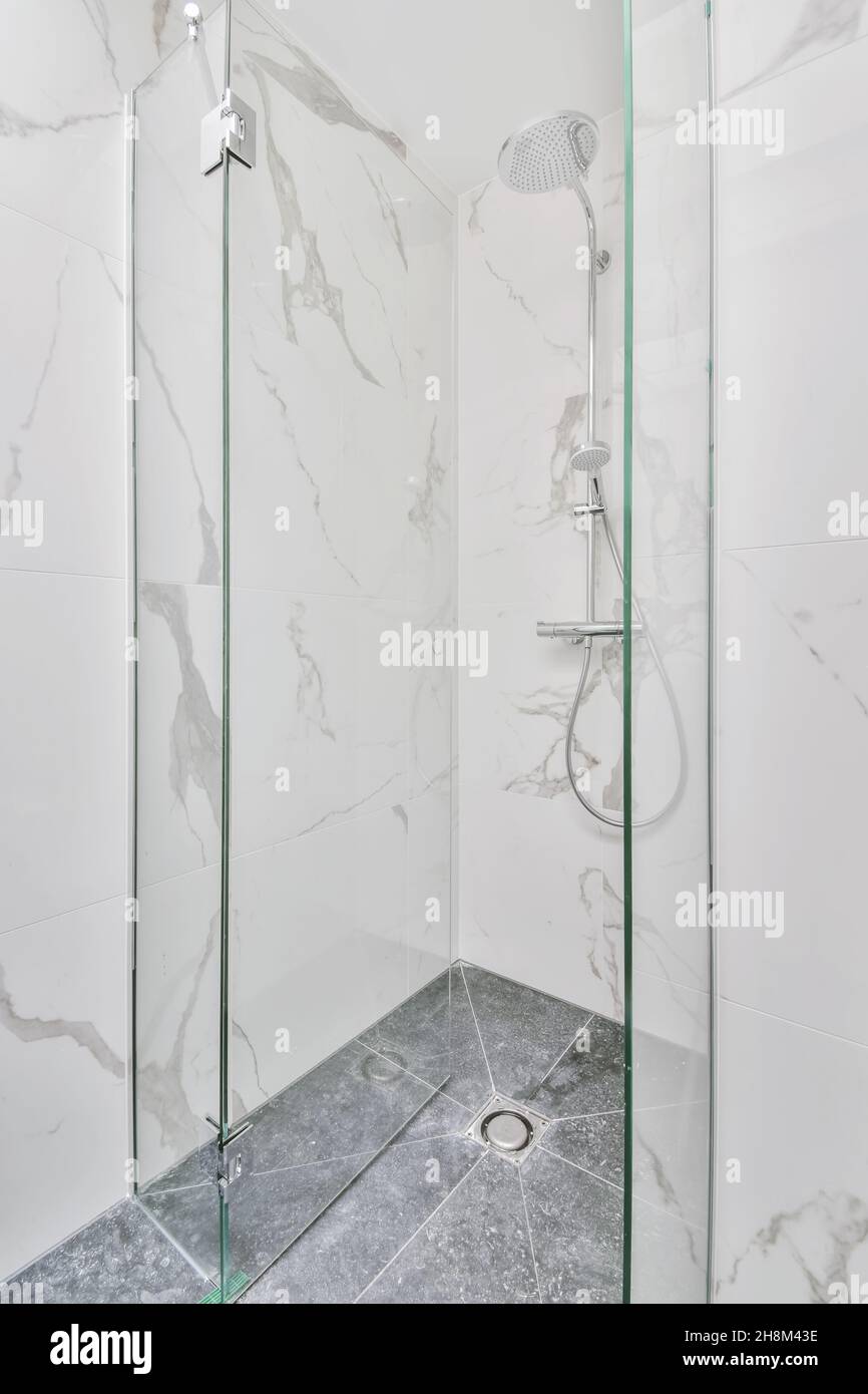 Tiled shower cubicle with glass door in a modern apartment Stock Photo