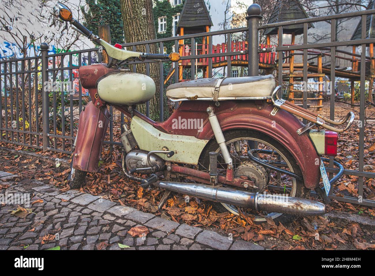 A vintage motorcycle next to a railing Stock Photo - Alamy