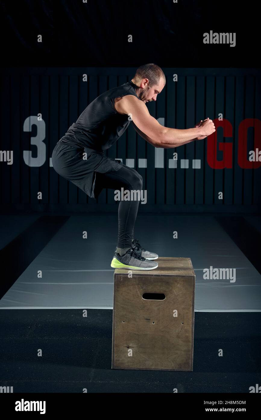 Deficit Jump Athlete gave exercise. Jumping on the box. Phase touchdown. Studio ...