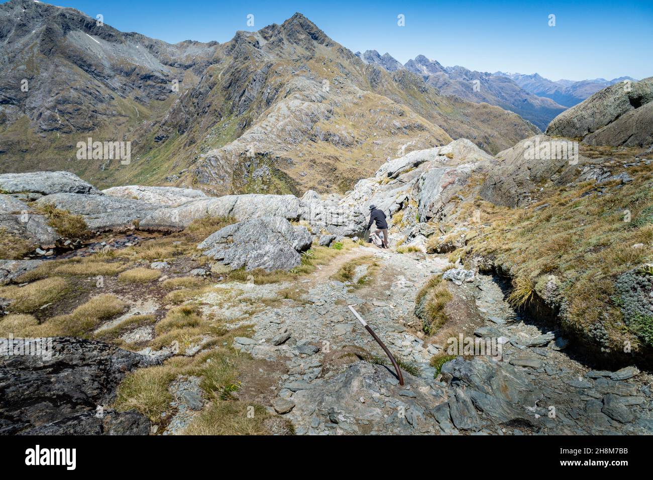 A tramper descending from Conical Hill towards Lake Harris, Routeburn