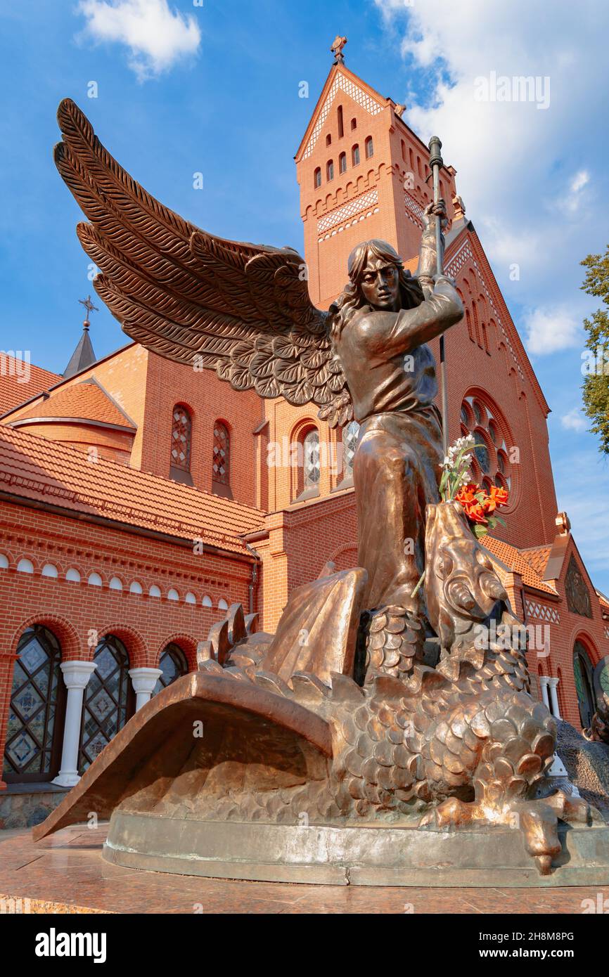 Monument to the Archangel Michael in front of the Catholic Church of St. Simon and Elena in Minsk in early autumn. Belarus Stock Photo