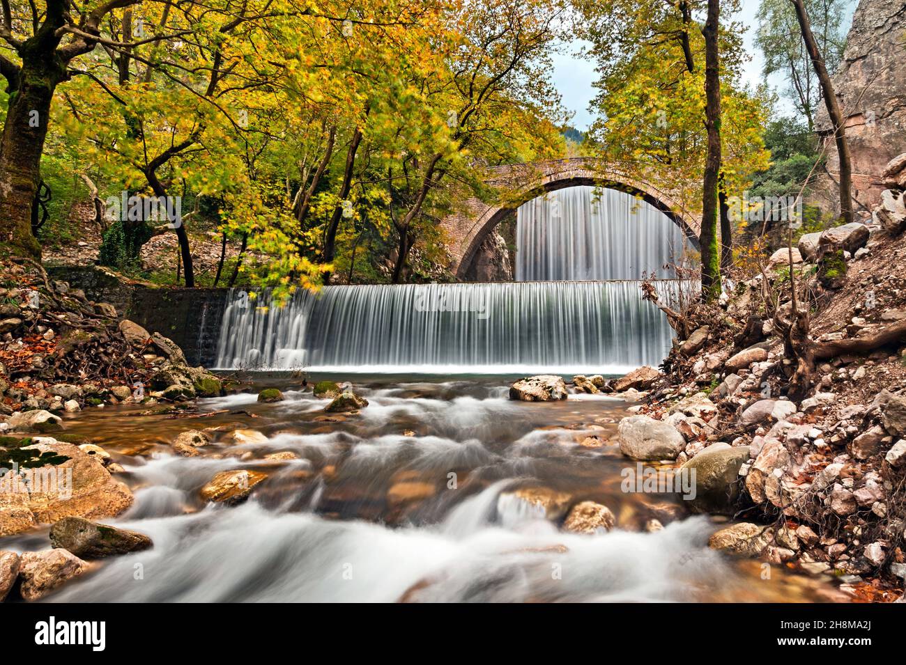 The old stone, arched bridge, between two waterfalls in Palaiokaria, Trikala prefecture, Thessaly, Greece. Stock Photo