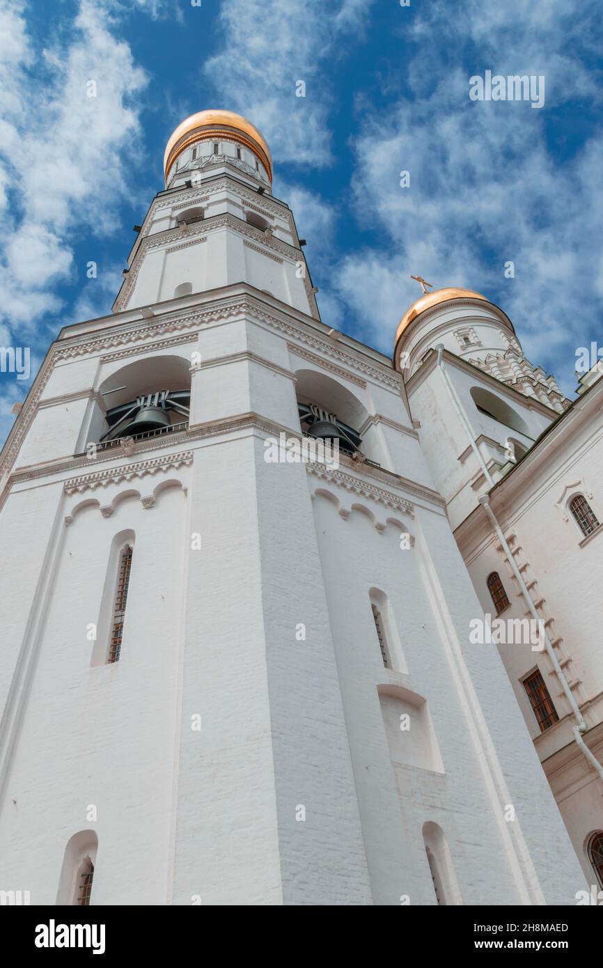 The bell tower of Ivan the Terrible is aimed at the sky. Cathedrals of the Moscow Kremlin. Stock Photo