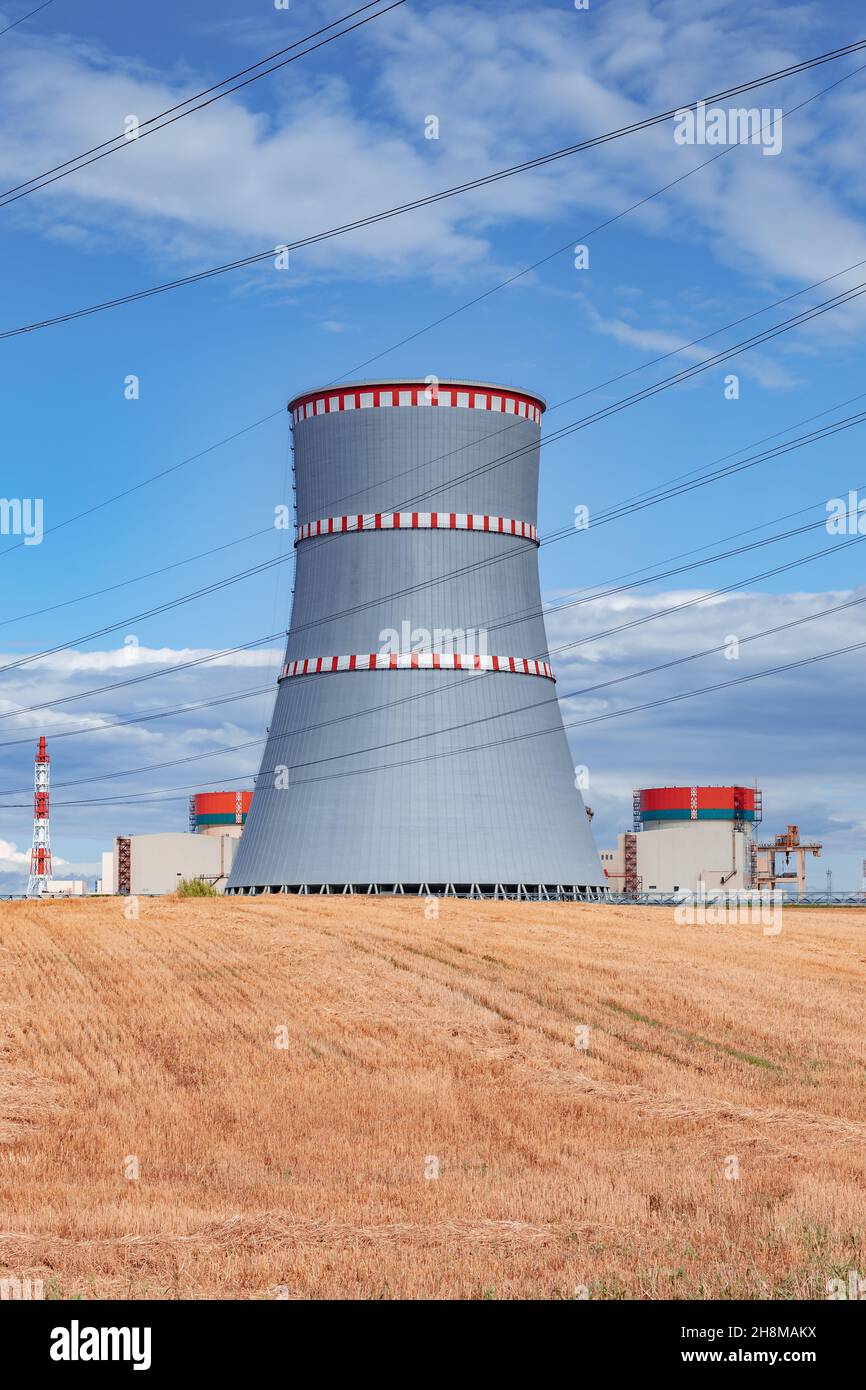 Scenic view of nuclear power plant, cooling tower and wires of high voltage line in Ostrovets, Belarus Stock Photo