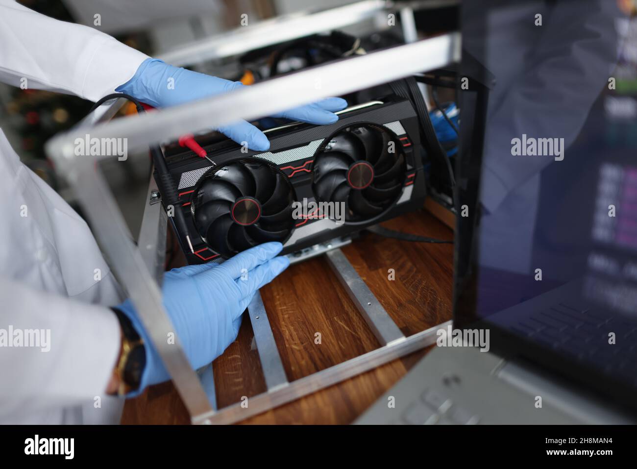 Man mechanic installing cooler fan with copper tubes on computer processor Stock Photo