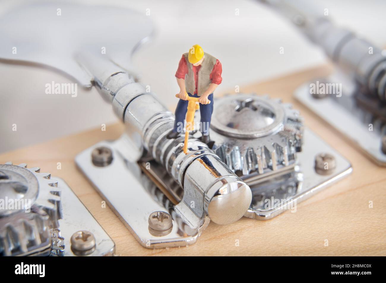 Miniature Worker Fixing The Bass Guitar Tuning Peg Stock Photo Alamy