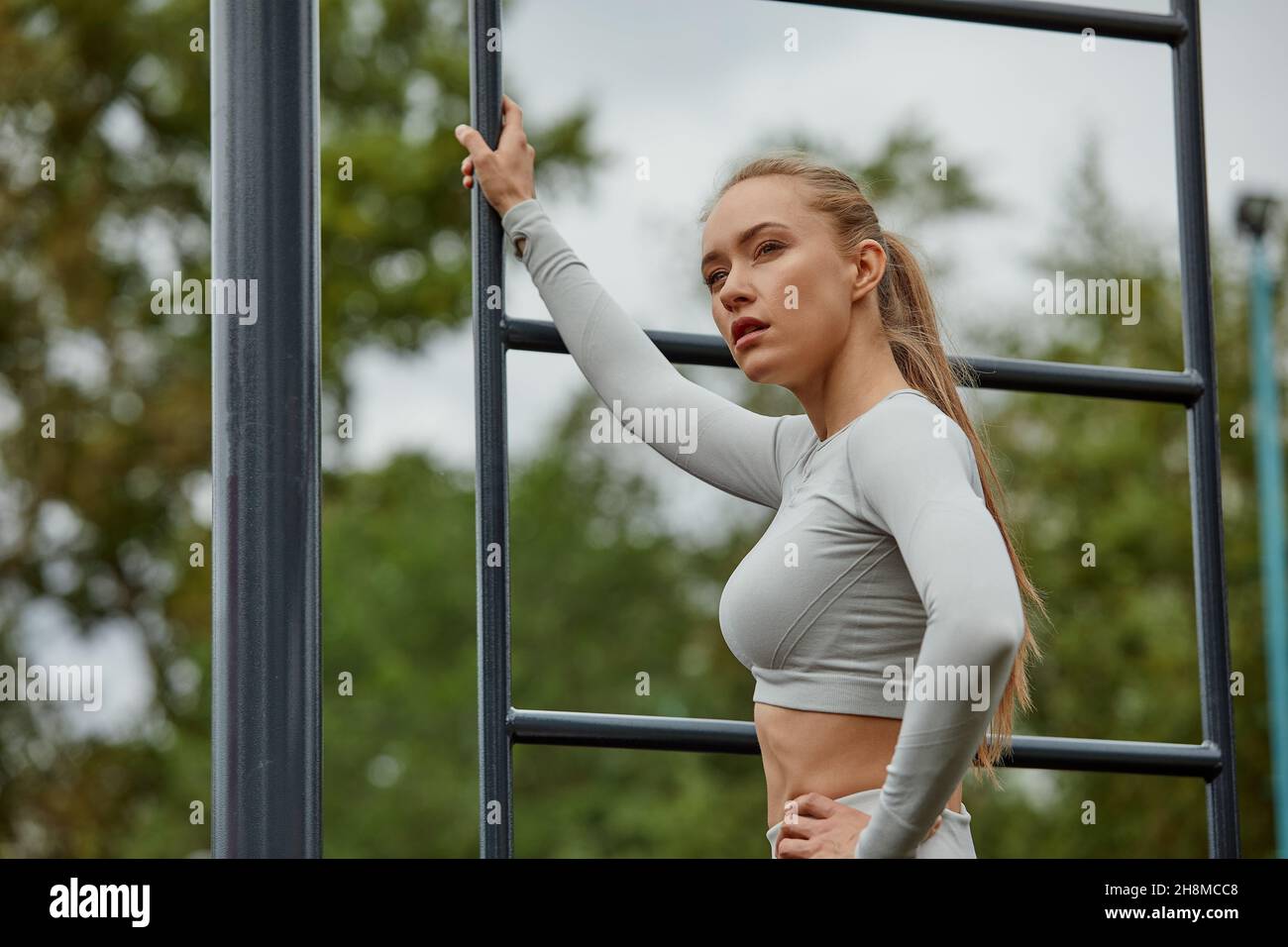 Woman exercising working out triceps and biceps doing dips with own