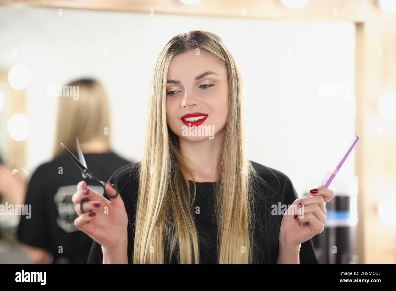 Portrait of young lovely professional master holding tools for work and posing. Qualified