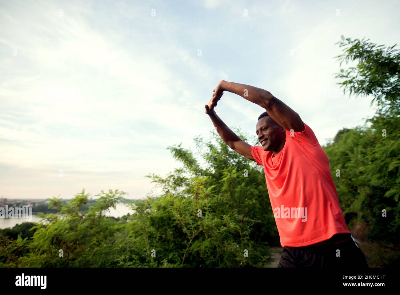 Young african american man stretching outdoor hi-res stock photography ...