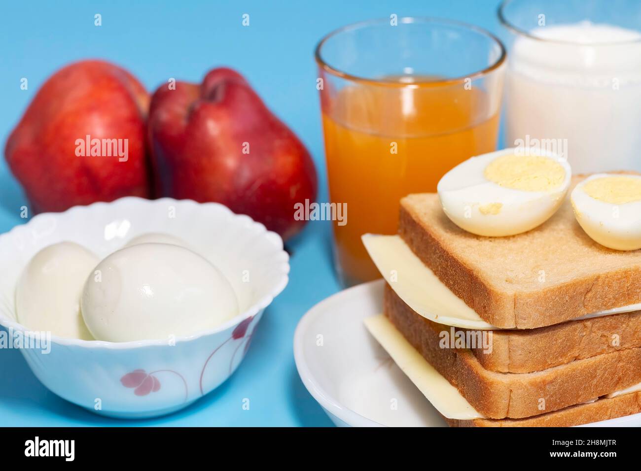 Healthy Indian breakfast with brown bread, cheese and sliced egg with