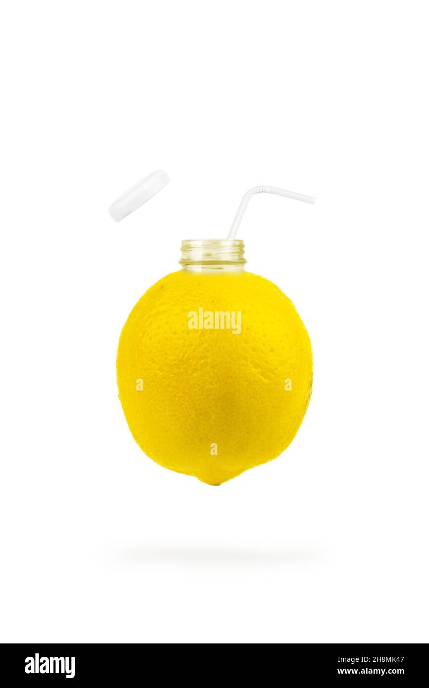 Lemon in the form of a bottle with open lid cap. Bottle of lemon juice and fresh lemons Stock Photo
