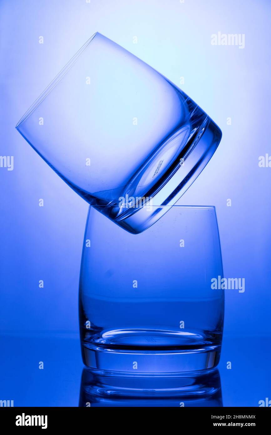 Empty glasses on the table with colorful gradient backlight ...