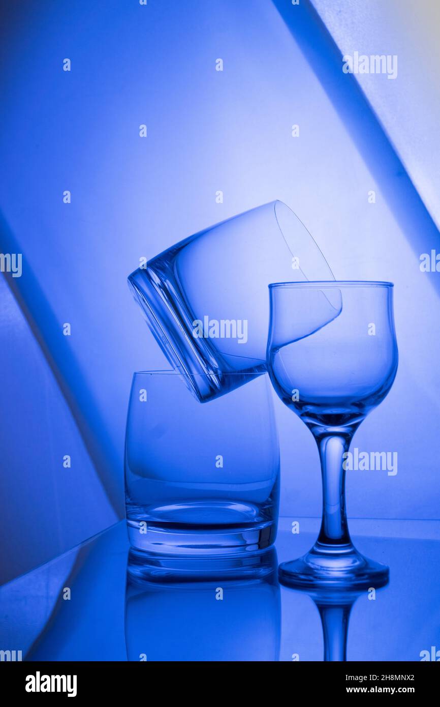 Empty glasses on the table with colorful gradient backlight ...