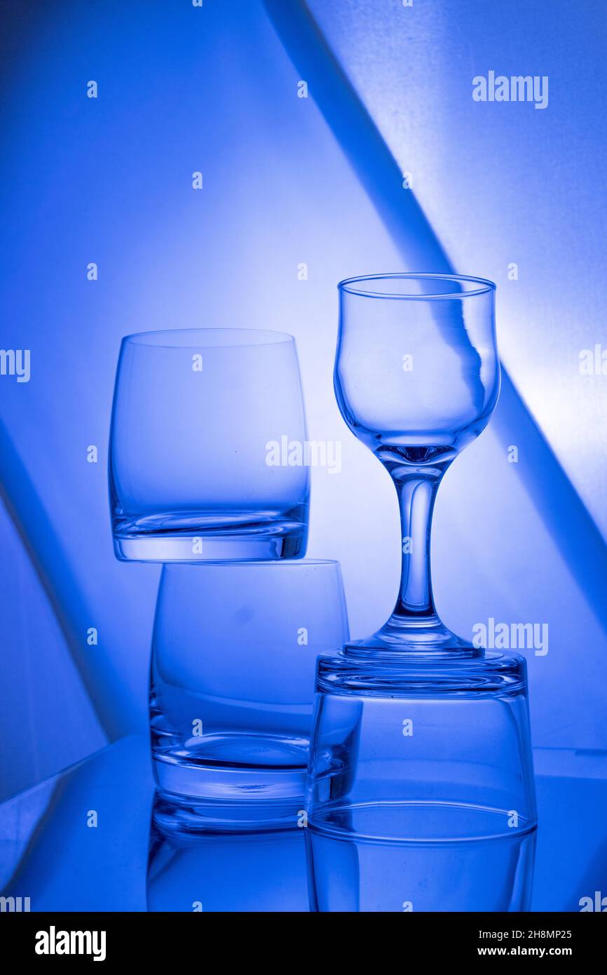 Empty glasses on the table with colorful gradient backlight ...