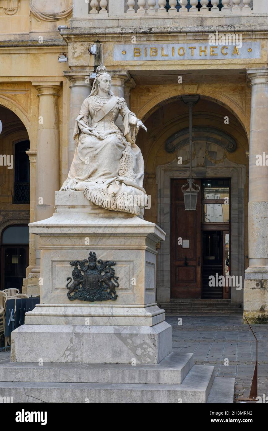 Marble statue of Queen Victoria in front of entrance to National Library of Malta building, Valletta, Malta Stock Photo