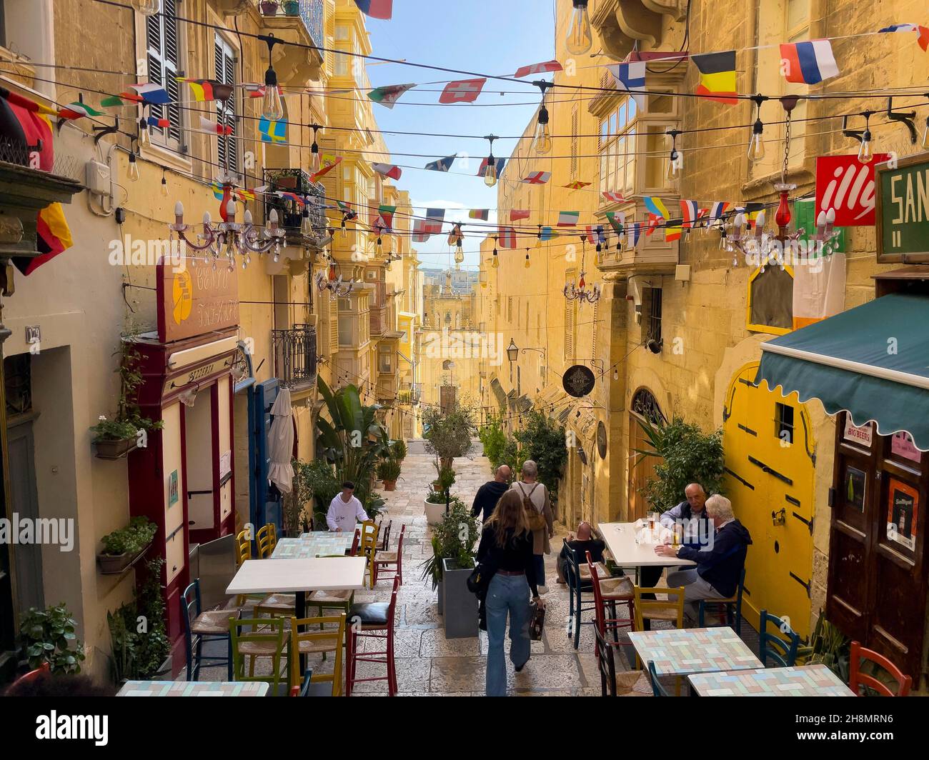 Steep narrow alley with cafes in Valletta Old Town, Valletta, Malta Stock Photo Alamy