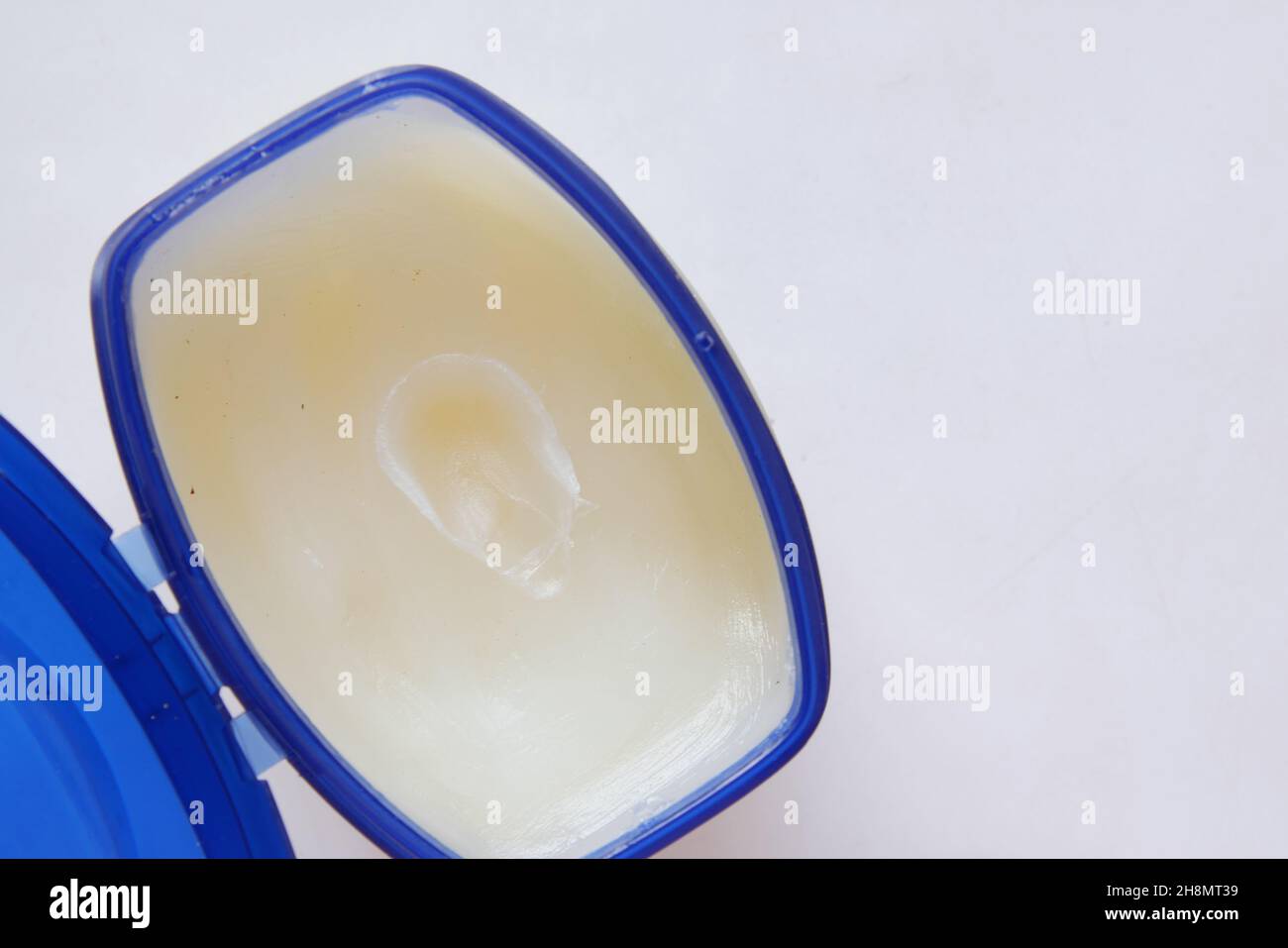 Close up of used petroleum jelly in a container  Stock Photo