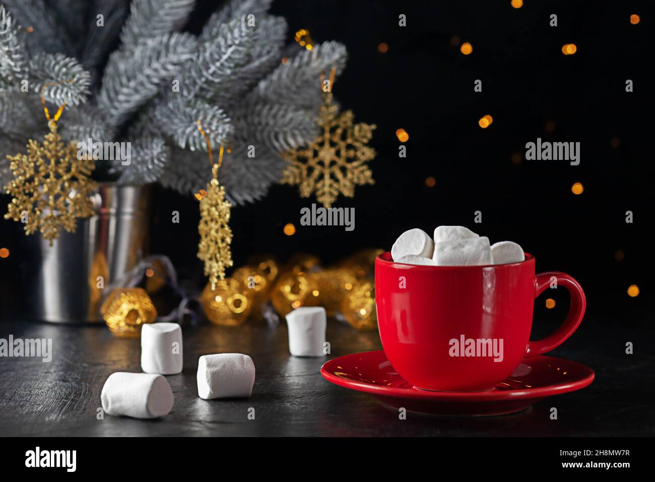 Marshmallows and a cup of latte on the background of Christmas tree Stock Photo