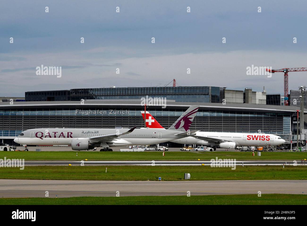 Aircraft Qatar Airways, Airbus A350-900, A7-ALI, r. Swiss Airbus A330-300, HB-JHE, Zurich Kloten, Switzerland Stock Photo