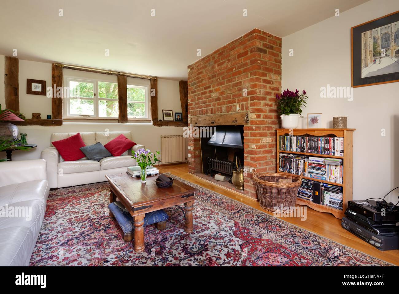 Thriplow, Cambridgeshire, England - August 9 2019: Lounge living room inside traditional british with exposed brick fireplace. Stock Photo