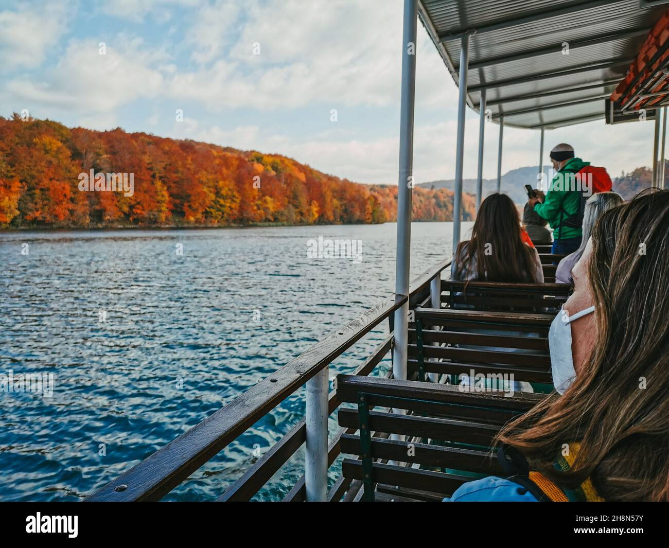 PLITVICE, CROATIA - Oct 29, 2021: A group of people on a tourist boat at famous Plitvice Lakes National Park in Croatia in autumn Stock Photo