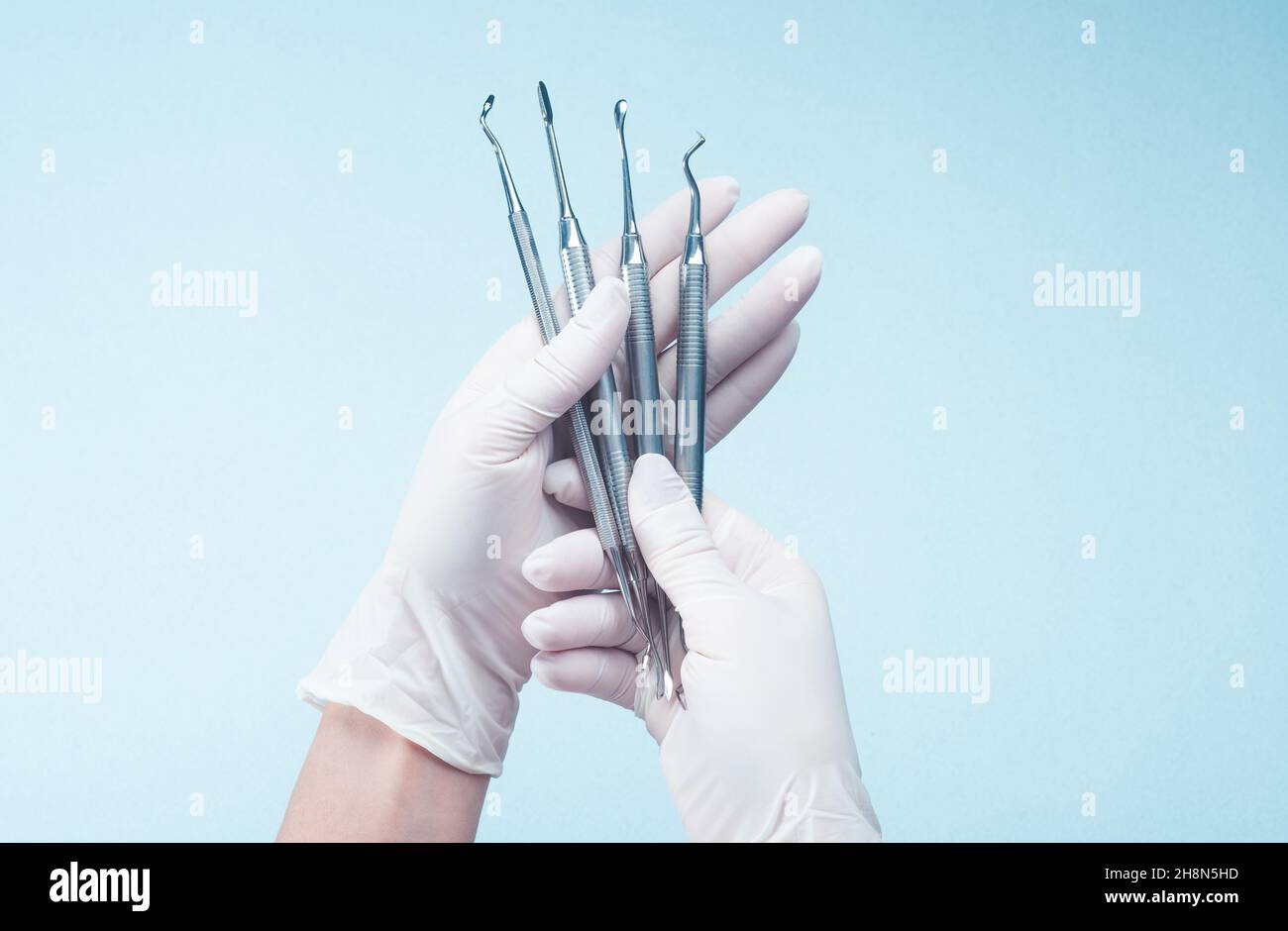 Hands in gloves holding medical tools Stock Photo
