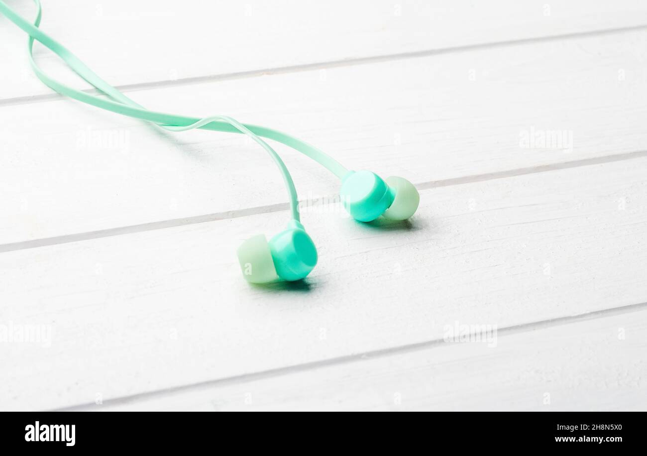 Digital earbuds on the table, macro with copyspace Stock Photo
