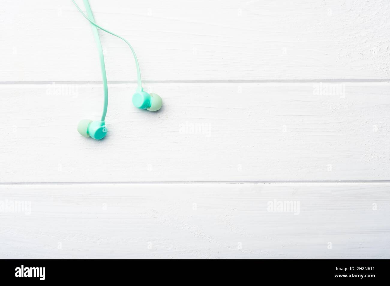 Digital earbuds on the table, macro with copyspace Stock Photo