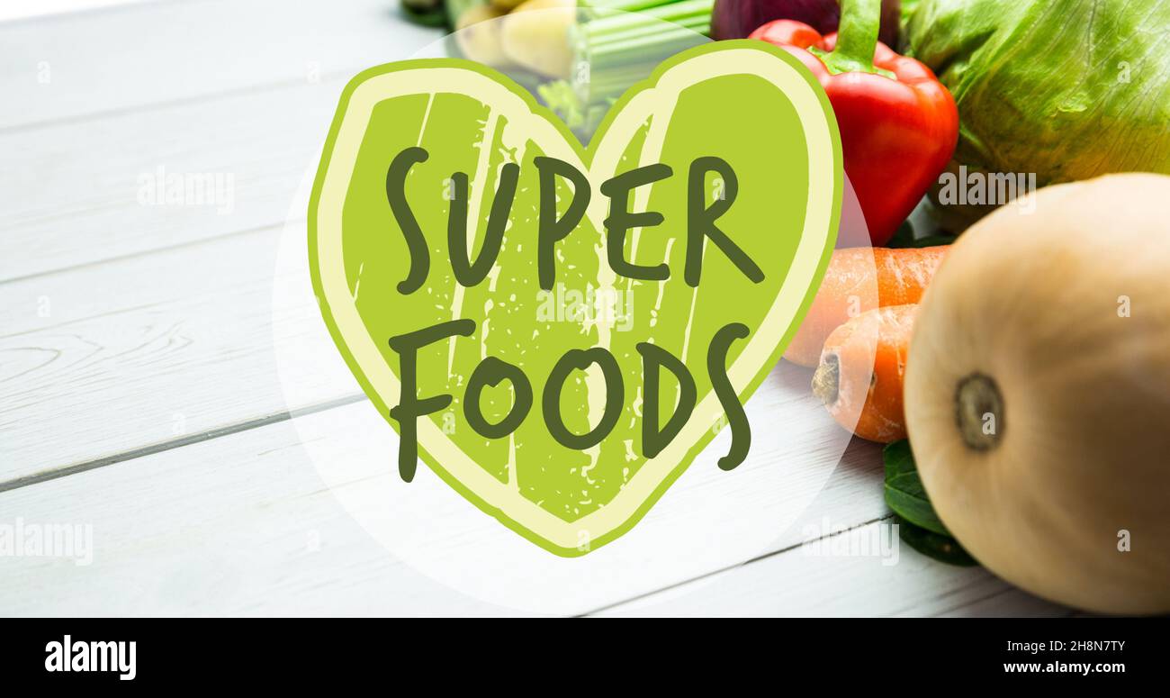 Super foods on green heart shape symbol over fresh vegetables Stock Photo