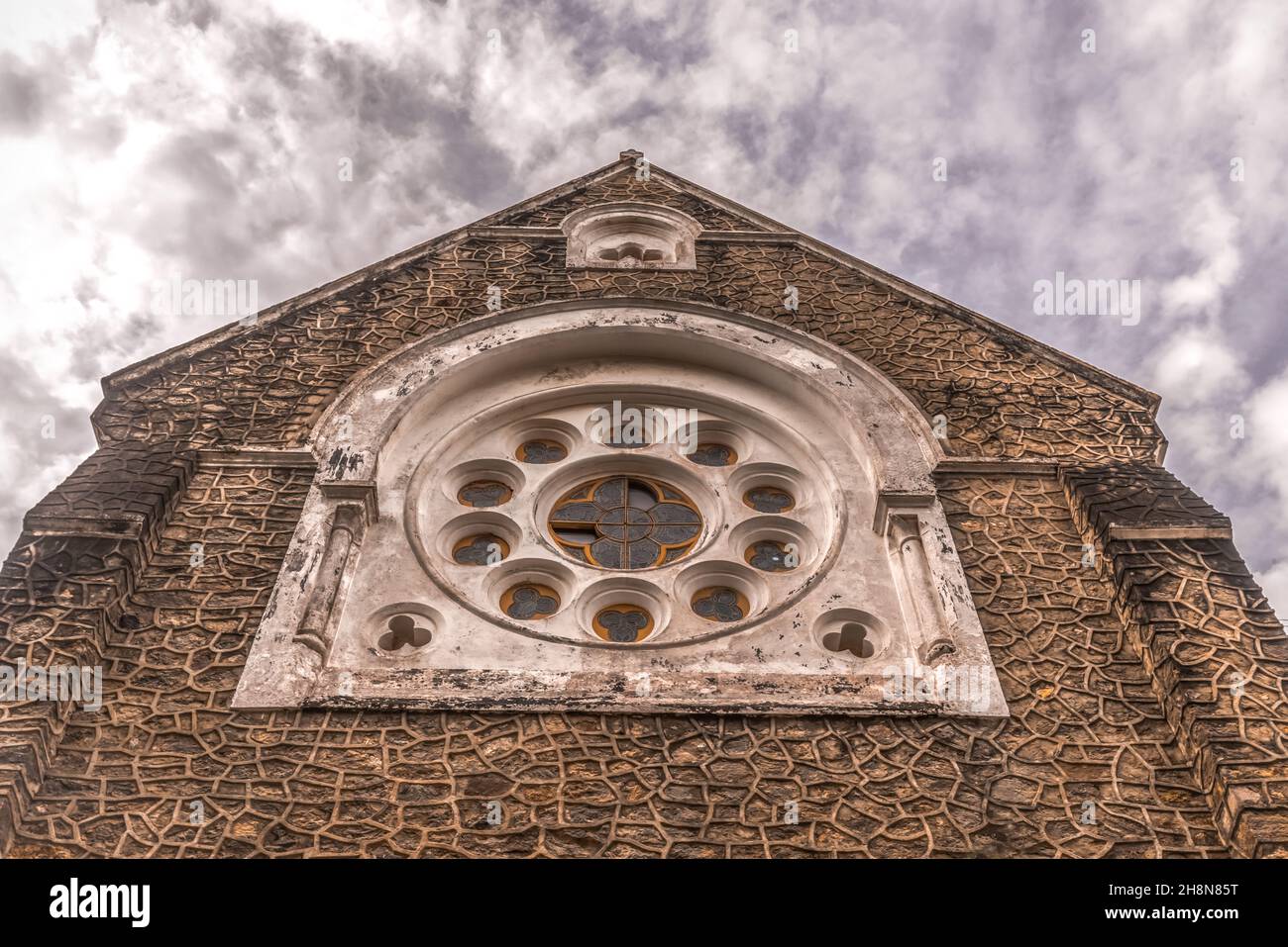Facade of the Catholic church with a cloudy sky background Stock Photo ...