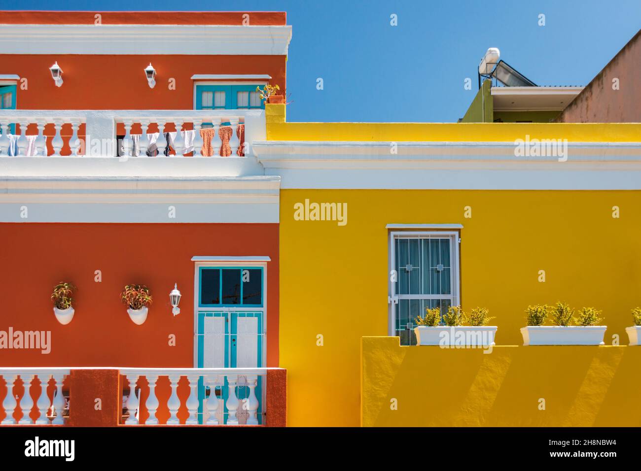 Colorful facades of old houses in orange and yellow, Bo Kaap Malay Quarter, Cape Town, South Africa Stock Photo