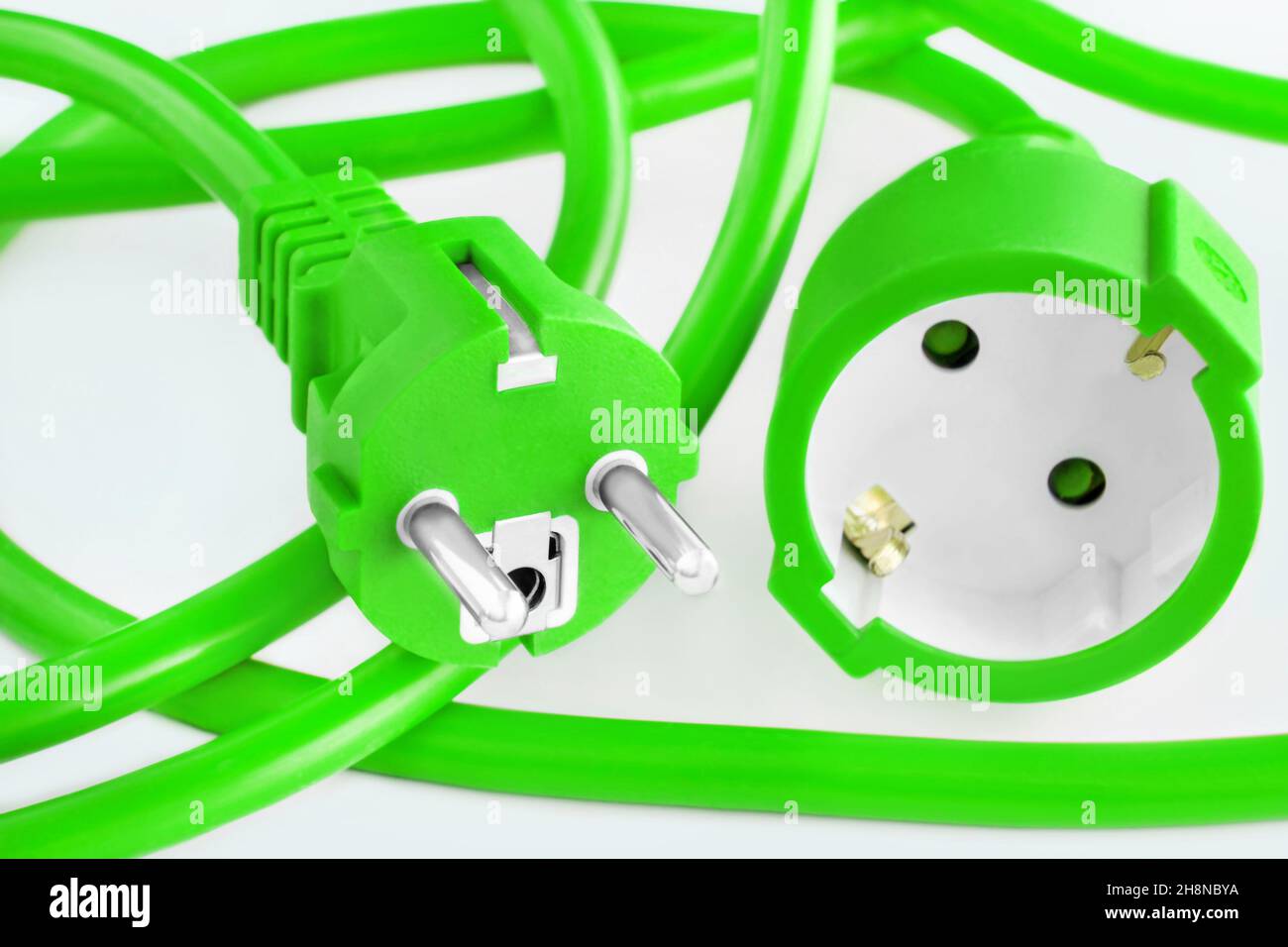 Green energy with cable and plug against white background closeup Stock ...