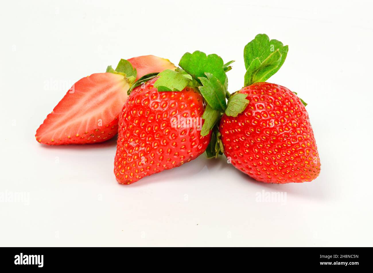Three fresh strawberries isolated on white background Stock Photo - Alamy