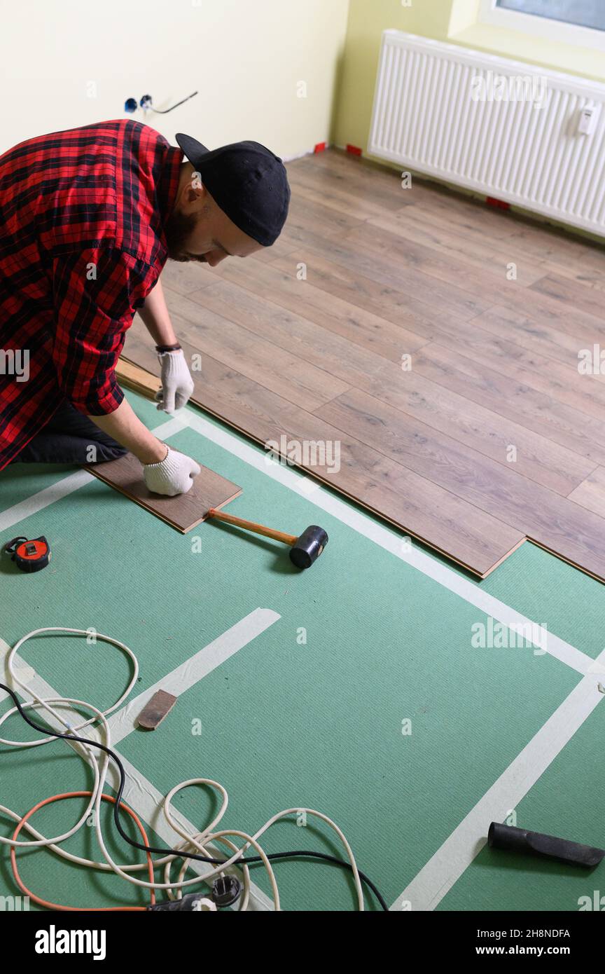 Repair of the apartment, laying laminate flooring. Construction Stock ... - Apartment Flooring Repair Contractors