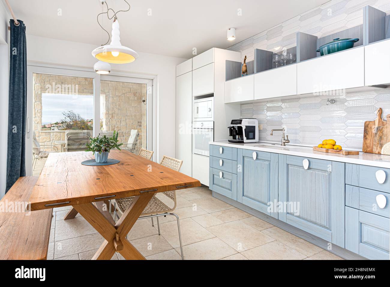 Combination of classic and modern kitchen in white and blue color with ...