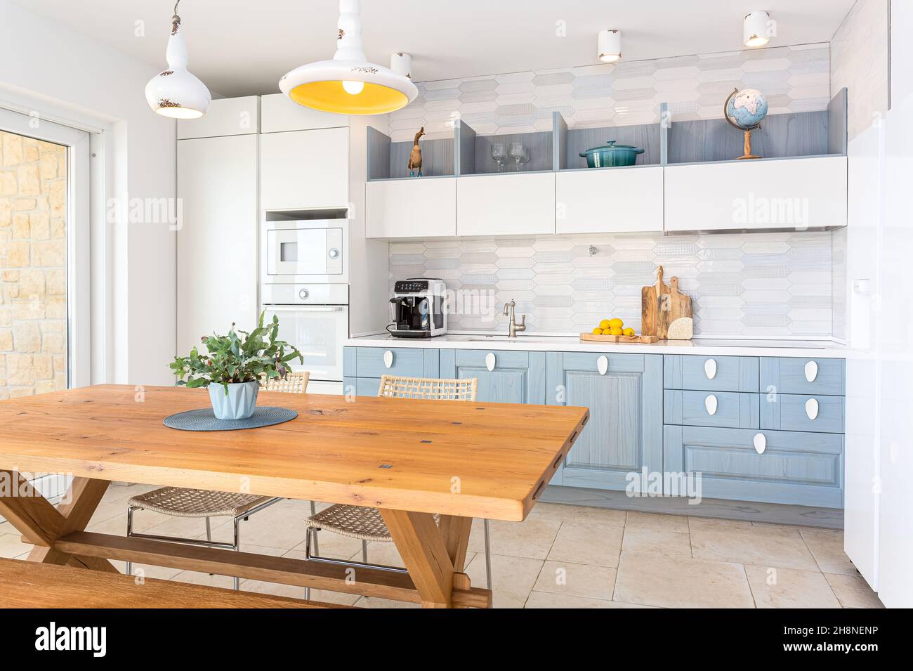 Combination of classic and modern kitchen in white and blue color with ...