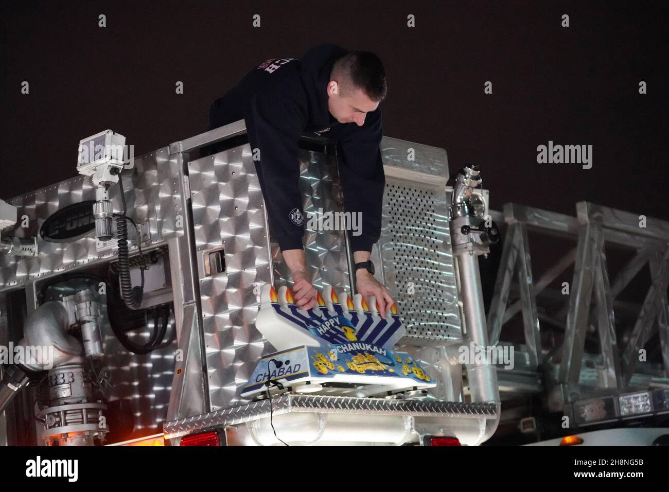 Chesterfield, United States. 30th Nov, 2021. A Monarch firefighter places a giant menorah on top of his fire truck before the start of the annual Chanukah menorah parade in Chesterfield, Missouri on Tuesday, November 30, 2021. Cars travel for several miles in the parade with a lighted menorah attached to their cars, listening to Chanukah music. Photo by Bill Greenblatt/UPI Credit: UPI/Alamy Live News Stock Photo