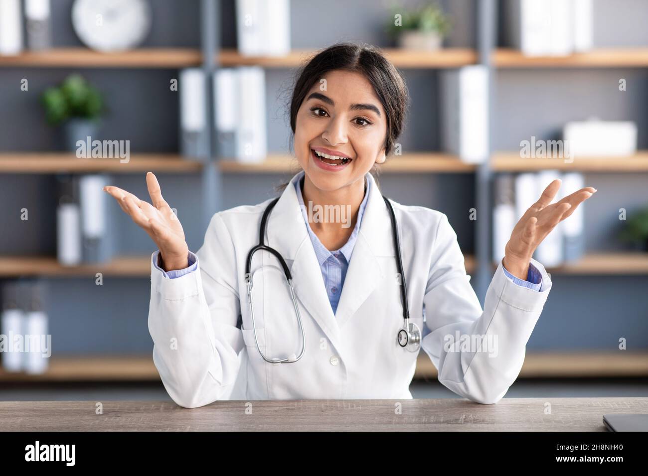 Smiling millennial attractive indian woman doctor in white coat ...