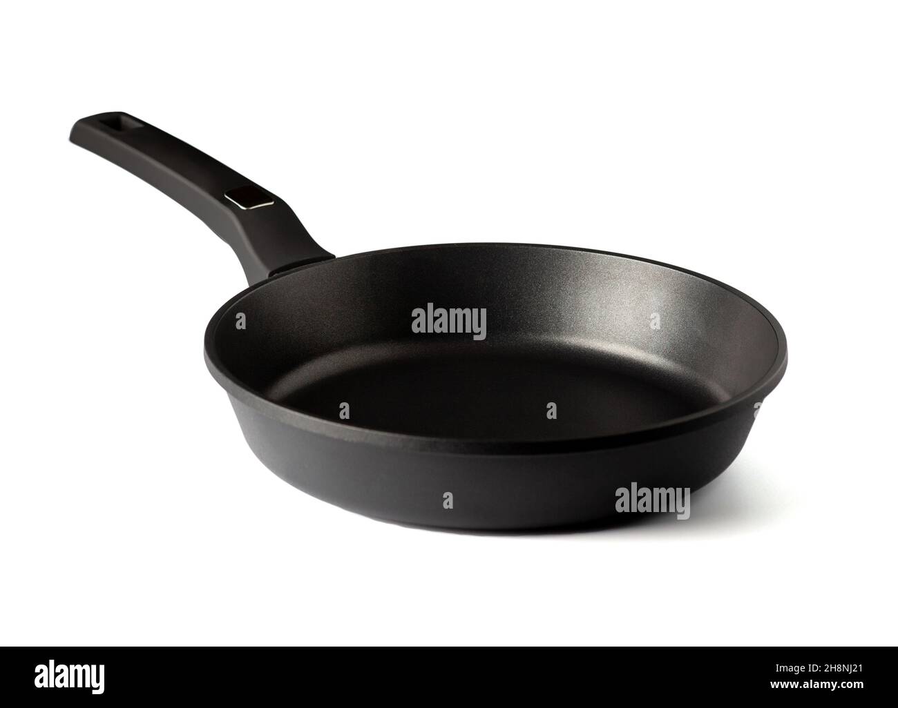 Frying pan with non-stick coating isolated on white background. New kitchen utensil cookware. Close up. Stock Photo