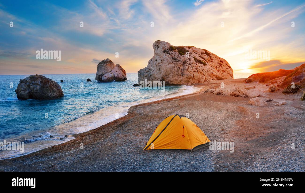 Orange tourist tent on the beach of Aphrodite in Cyprus Stock Photo