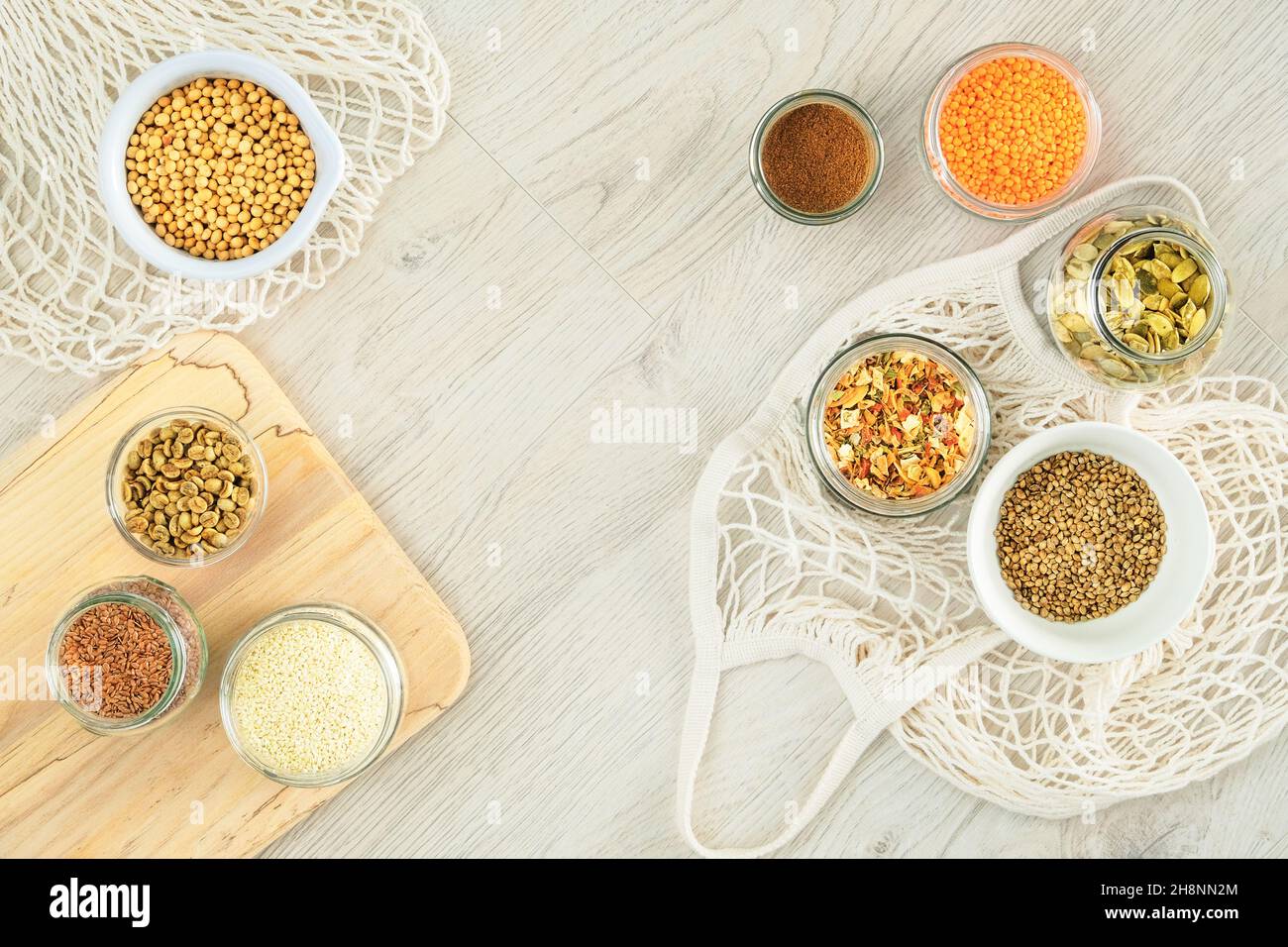 Zero waste shopping and sustanable lifestyle concept. Various farm organic products in glass jars on a light wooden background. Copy space, top view. Stock Photo