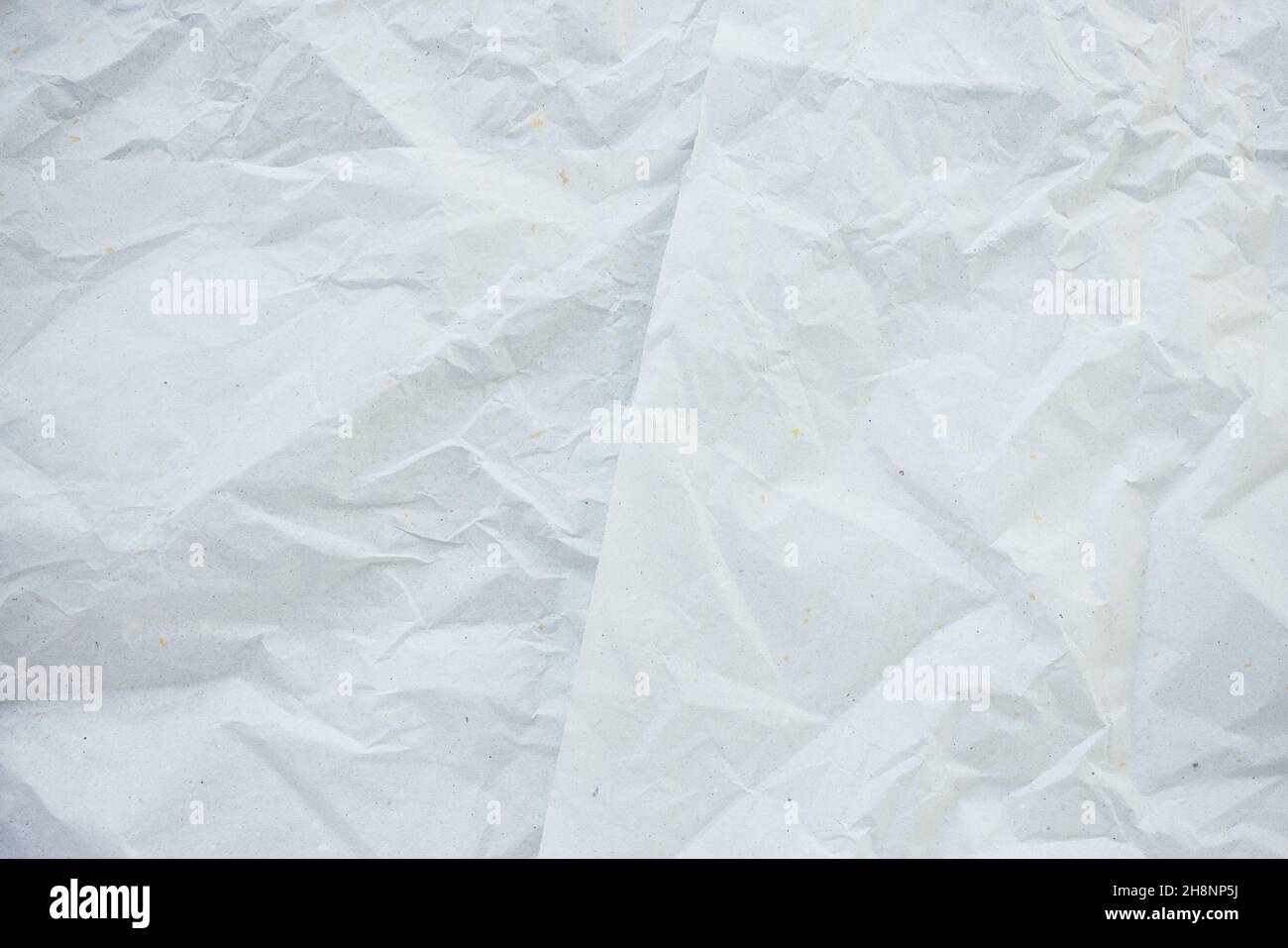 Crumpled white with color dots paper for gift wrapping or packaging. Closeup, texture background, pollution and recycling concept Stock Photo