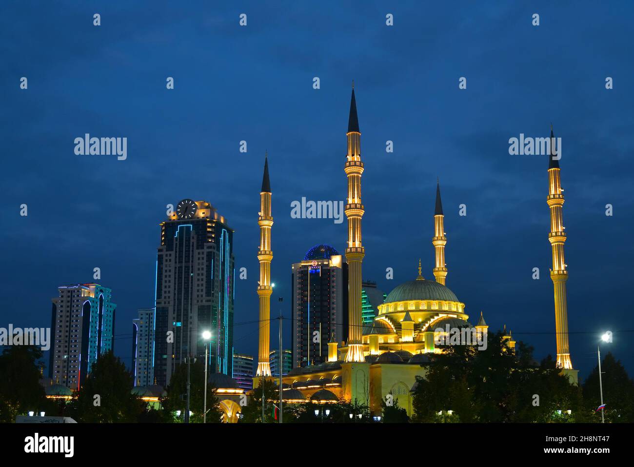 Grozny, Chechnya, Russia - September 13, 2021: Akhmad Kadyrov Mosque Heart of Chechnya and skyscrapers of downtown shown at night Stock Photo